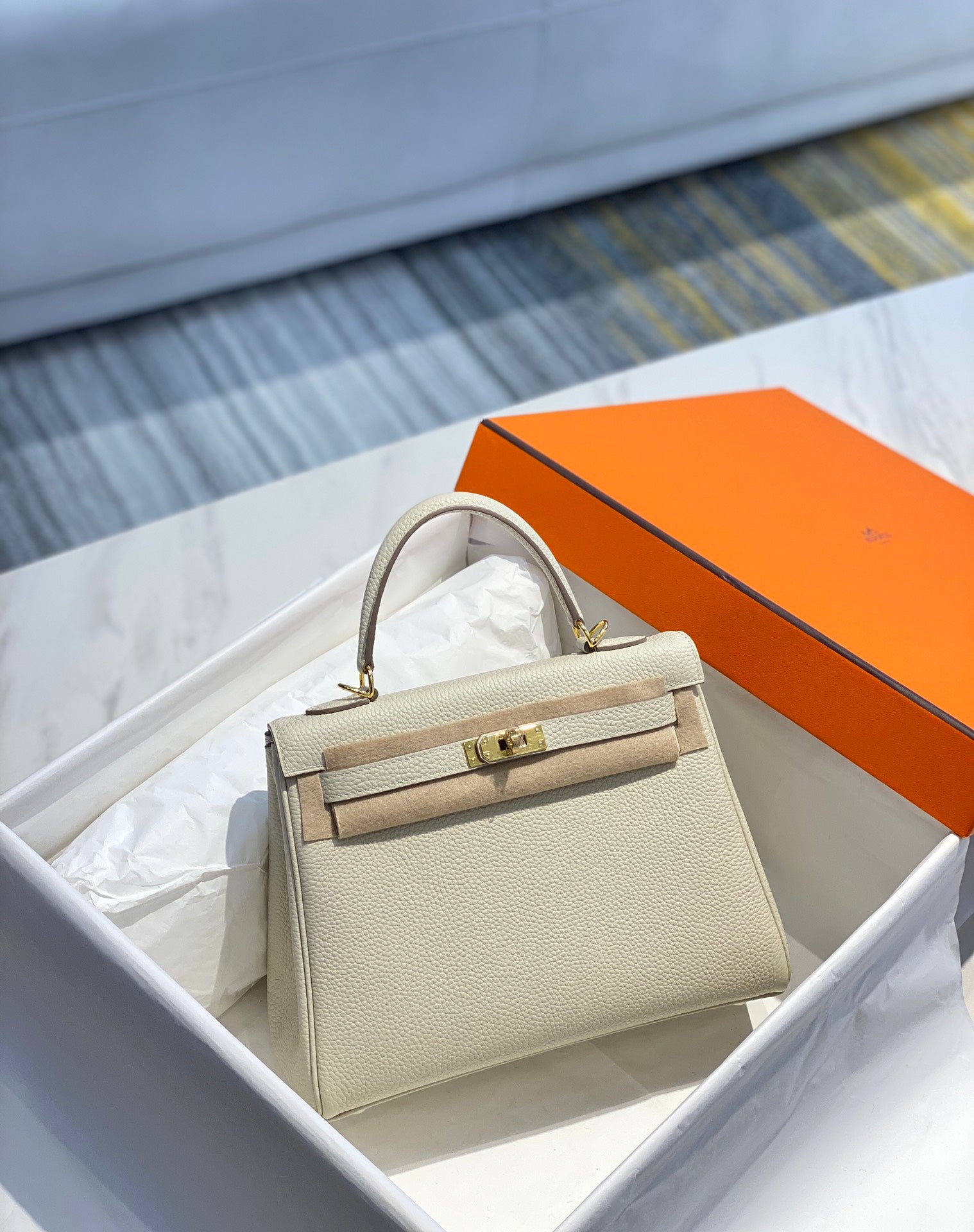 Sac HM Kelly 32 cm en cuir Togo crème et accessoires dorés