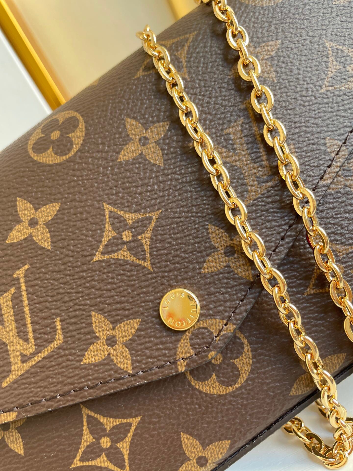 POCHETTE FÉLICIE 21 EN TOILE MONOGRAMME MARRON QUINCAILLERIE DORÉ