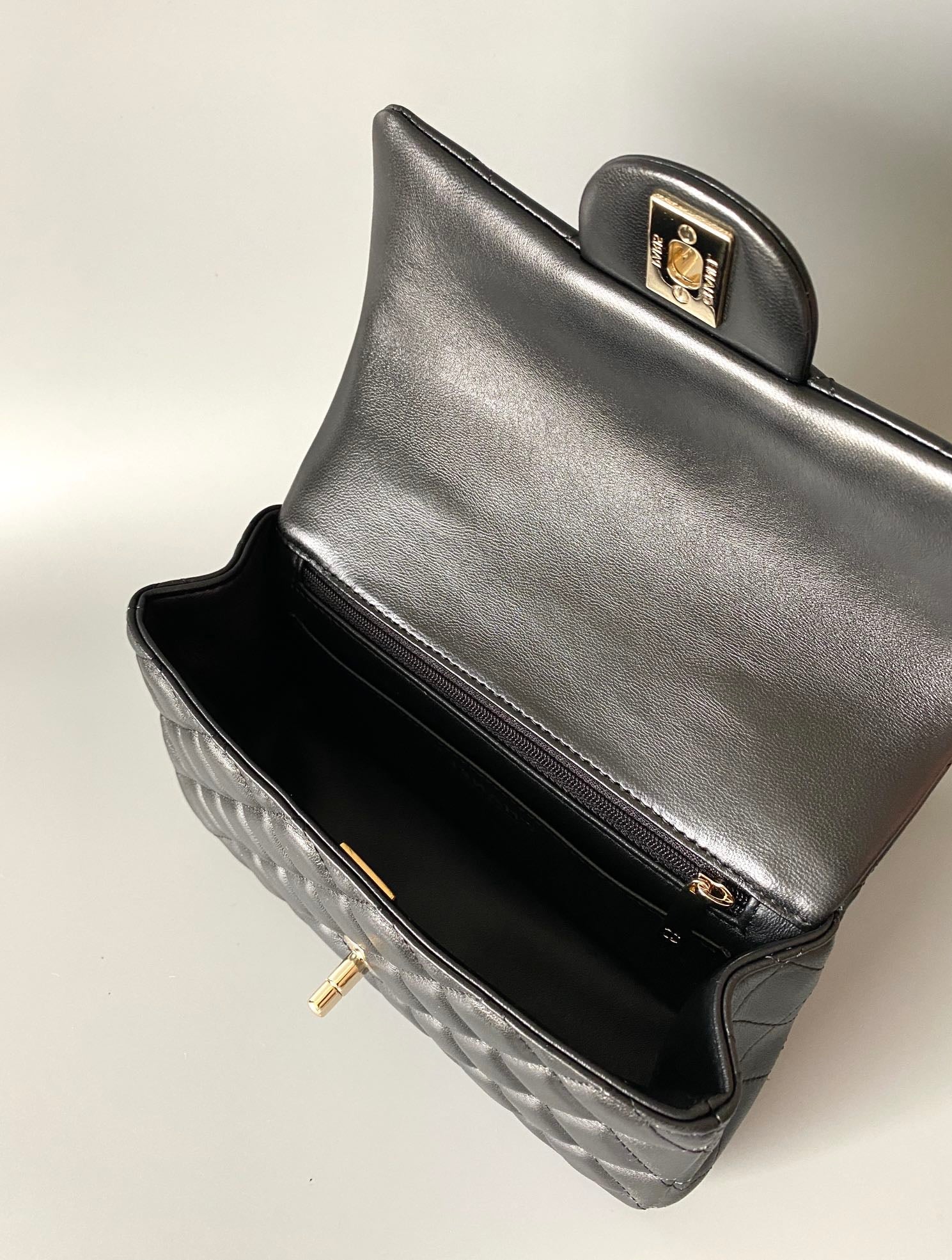 MINI SAC À RABAT AVEC POIGNÉE SUPÉRIEURE 20 CM EN CUIR D'AGNEAU NOIR ET QUINCAILLERIE DORÉ