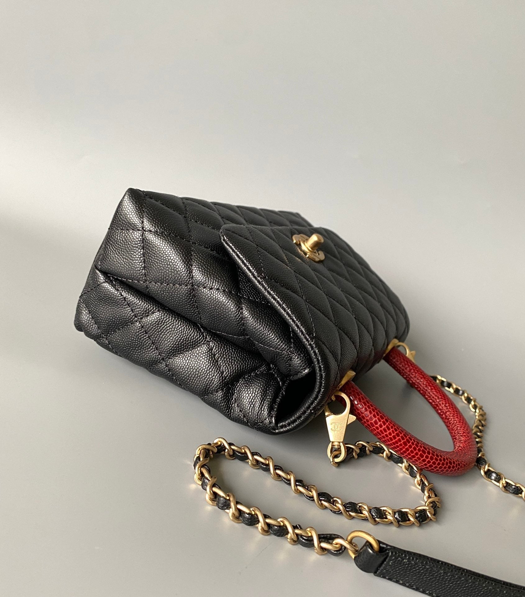 COCO HANDLE FLAP BAG 23CM BLACK QUILTED CAVIAR WITH RED TOP HANDLE