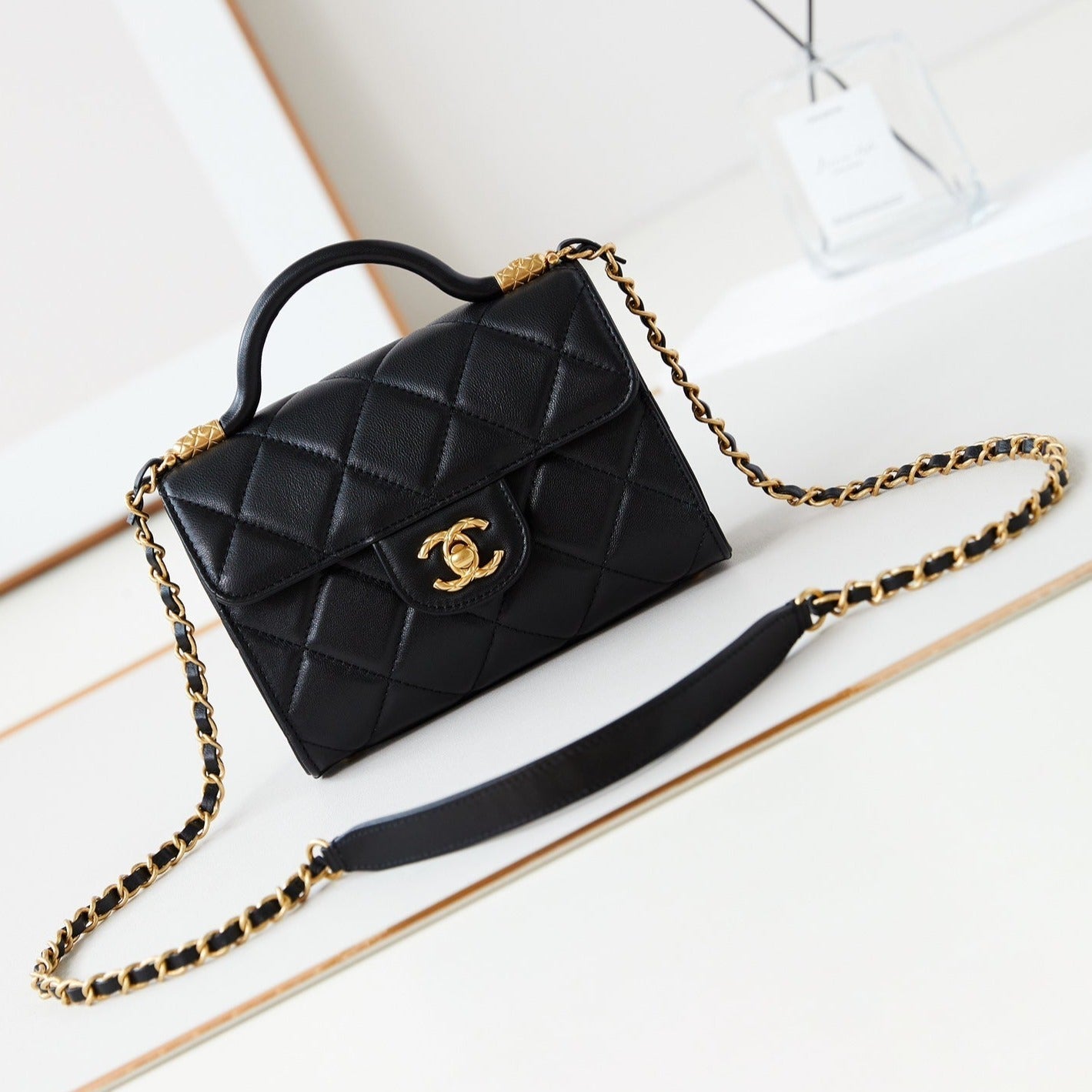 24A FLAP BAG WITH TOP HANDLE 18CM BLACK LAMBSKIN GOLD HARDWARE