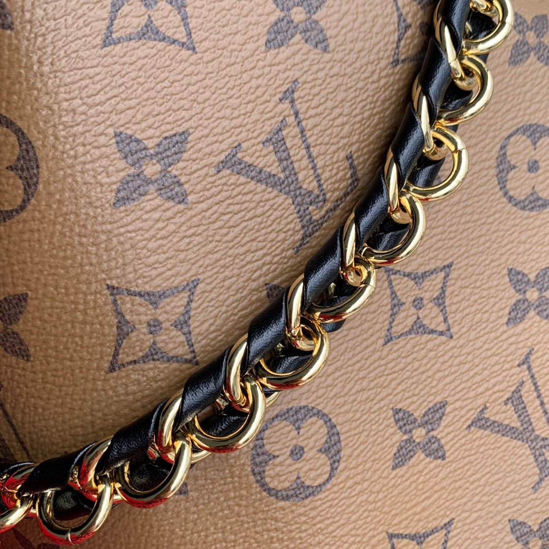 Malle Noé 23 en toile inversée monogrammée marron et quincaillerie dorée