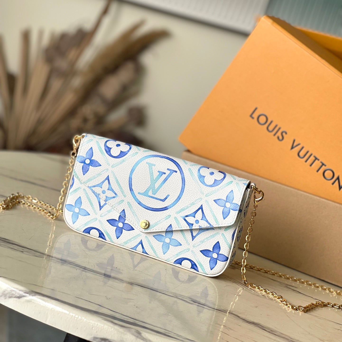 FÉLICIE POCHETTE 21 EN TOILE CARREAUX MONOGRAMME BLEU LAGON