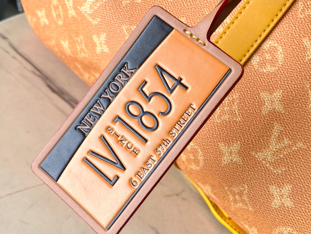 SAC KEEPALL BANDOULIÈRE 55 EN TOILE HÉRITAGE MONOGRAMME ORANGE