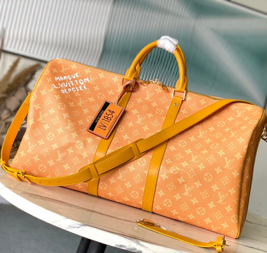 SAC KEEPALL BANDOULIÈRE 55 EN TOILE HÉRITAGE MONOGRAMME ORANGE