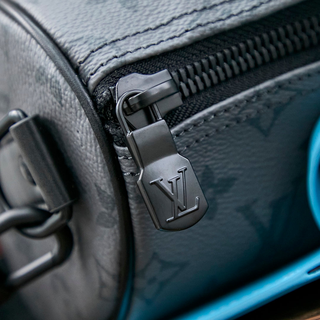 SAC BANDOULIÈRE KEEPALL 25 EN TOILE ÉCLIPSE MONOGRAMME GUN METAL CUIR DE VEAU TURQUOISE MIXTE