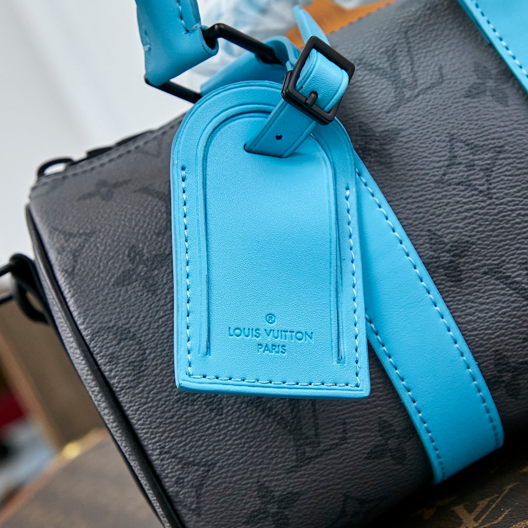 SAC BANDOULIÈRE KEEPALL 25 EN TOILE ÉCLIPSE MONOGRAMME GUN METAL CUIR DE VEAU TURQUOISE MIXTE